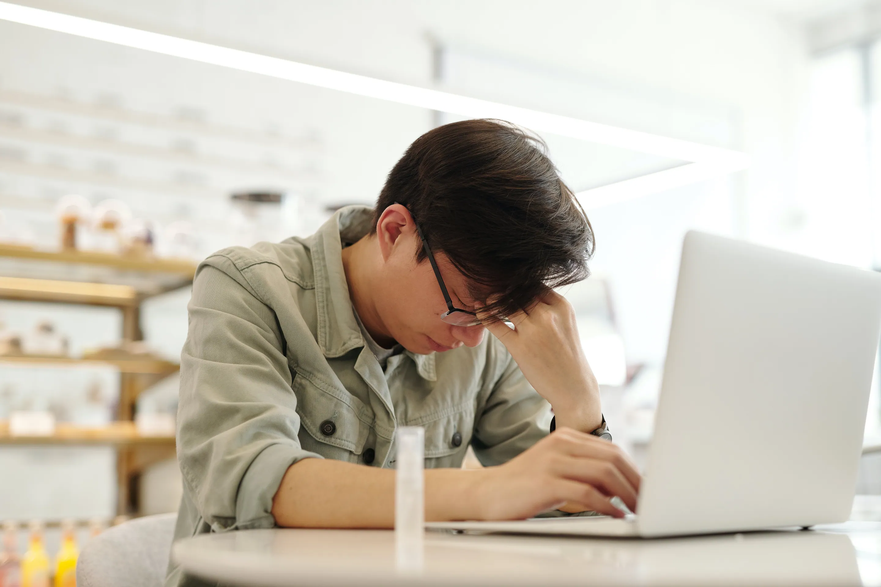 An Asian male suffering from a headache